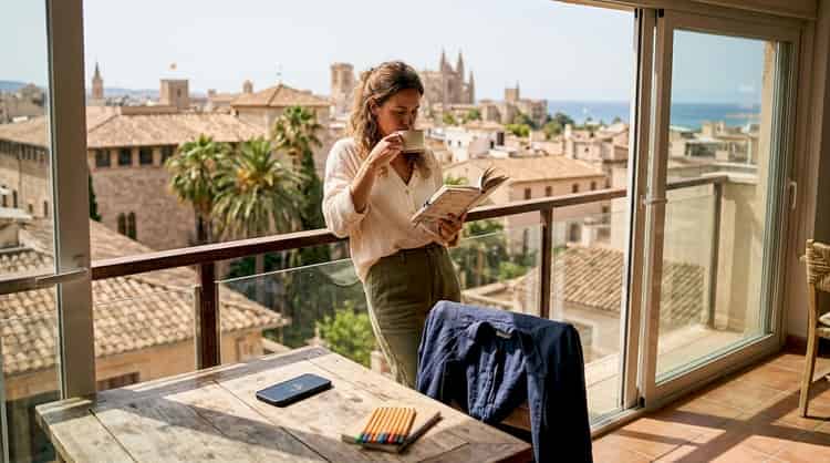 Professional enjoying spectacular views of Mallorca from their balcony